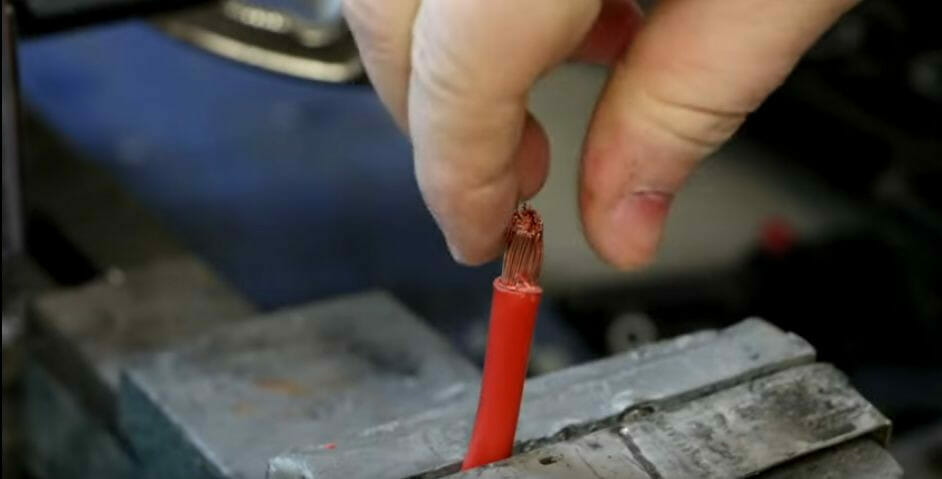 A person about to twist the copper strands