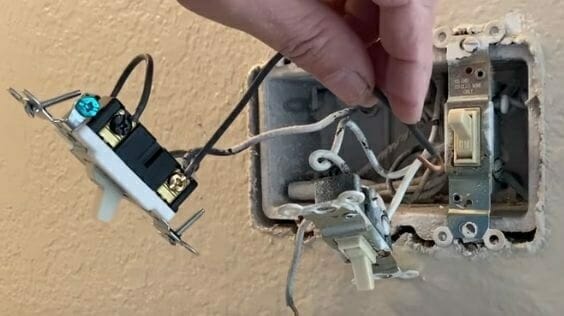 A person wiring a double pole switch