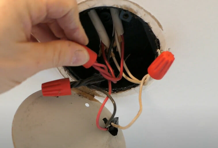 A person capping off the exposed wires