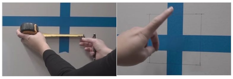A person measuring and marking the wall within the blue tape