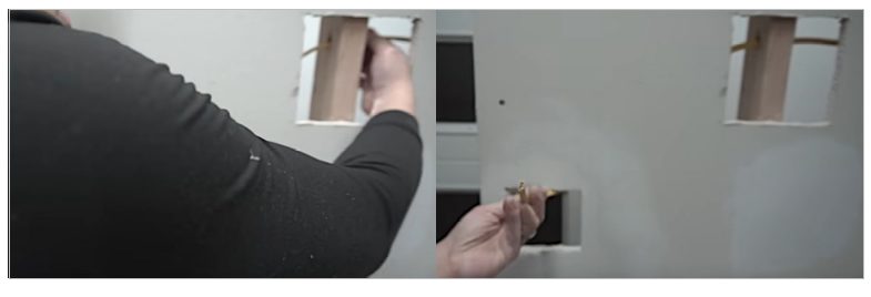 A person feeding the wire through the stud hole