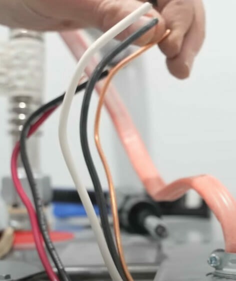 A person is wiring a machine