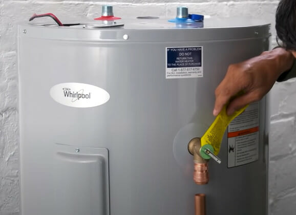 A man installing a hot water heater