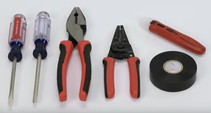 A set of pliers and other tools on a white surface