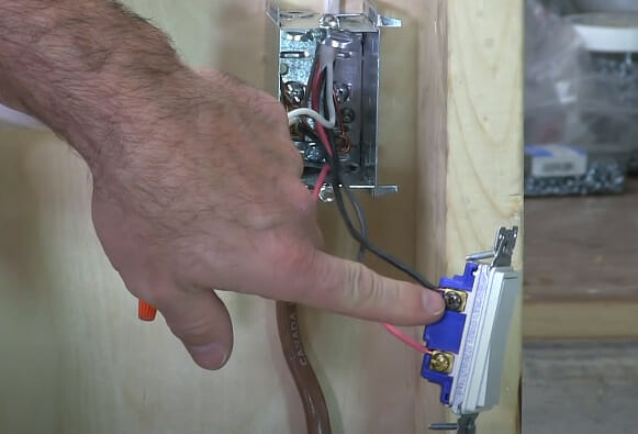 A person pointing at an outlet terminal