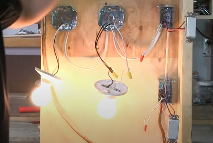 A person turning on the 2 lightbulb