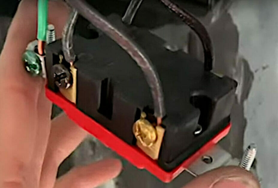 A person uses 2-conductor cables with two black wires