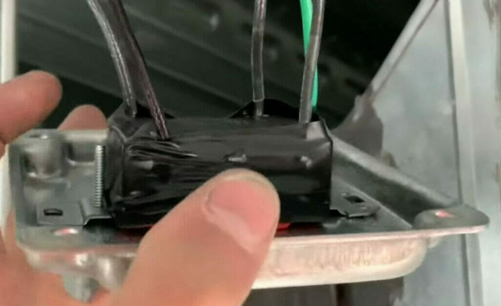 A person holding a wired switch