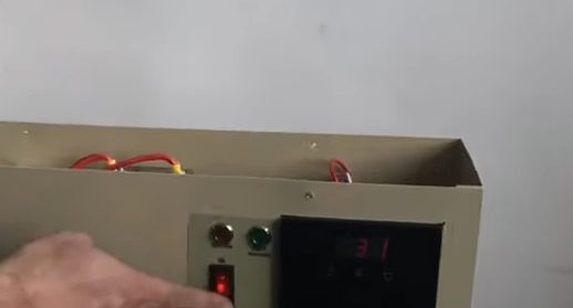 A person testing the electric pool heater
