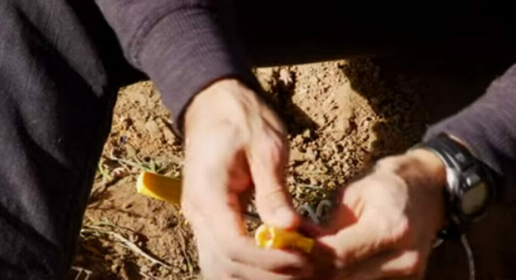 A man holding a connectors or Grease nuts