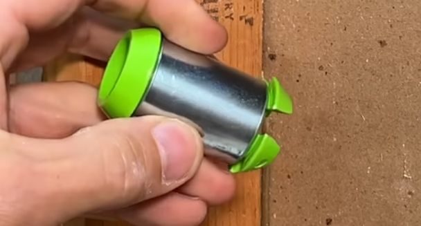 A person is holding a hole protector