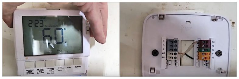 A person opening the thermostat cover