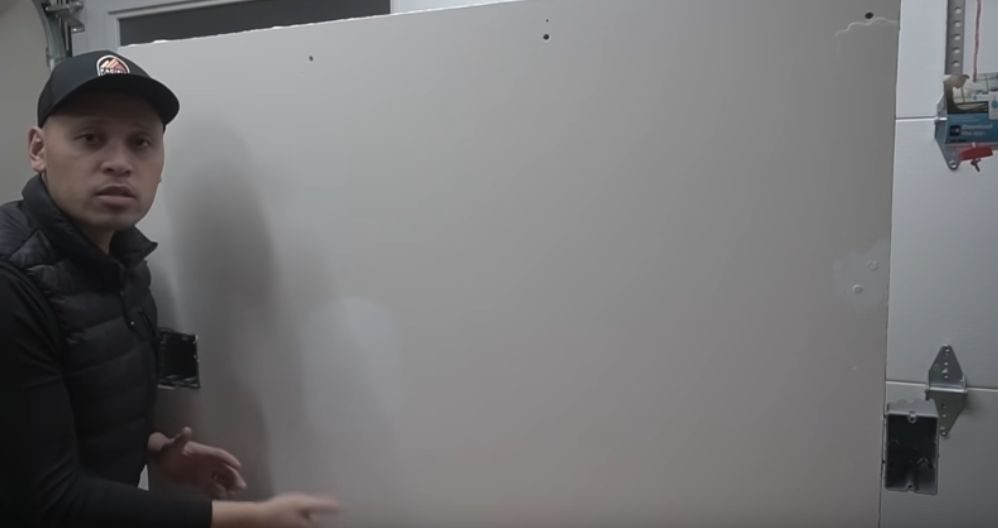 A man next to a finished grey wall