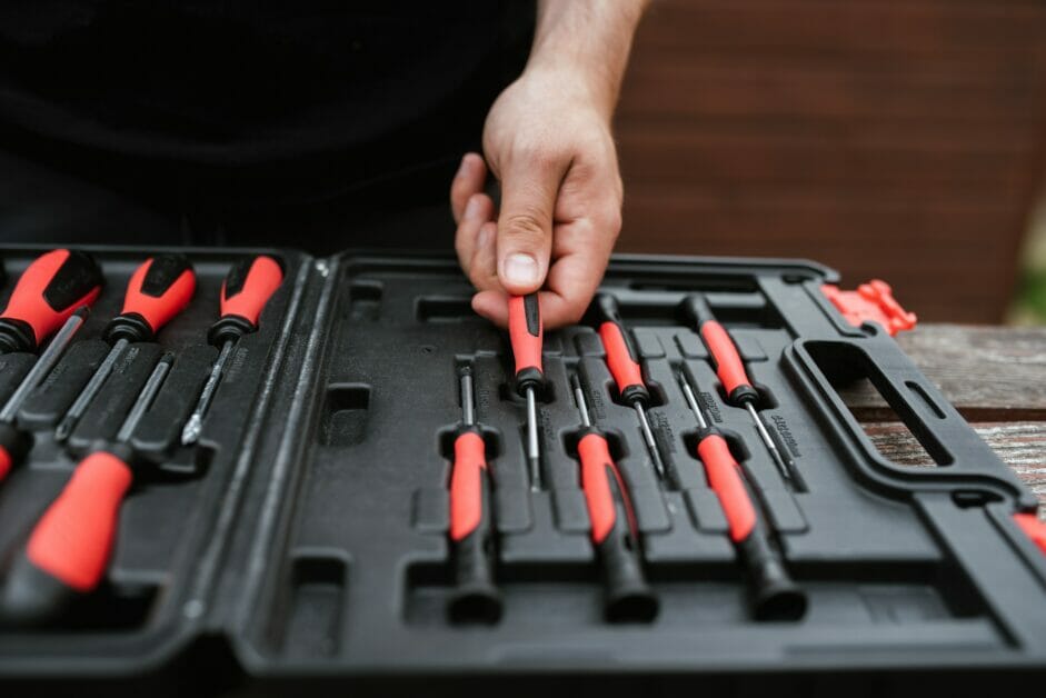 A person with his box collection of screwdrivers