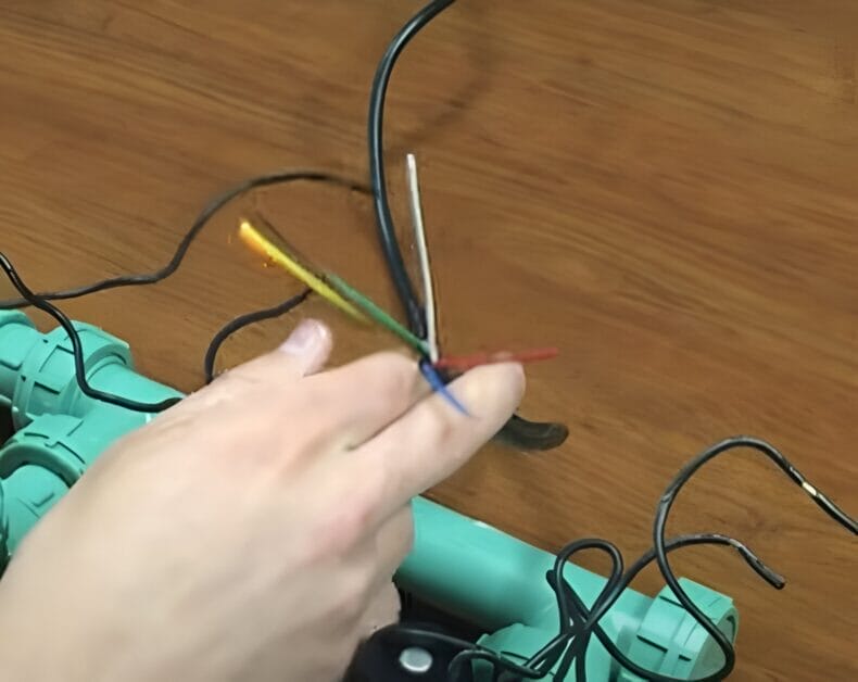 A person removing the covering from all the conductors