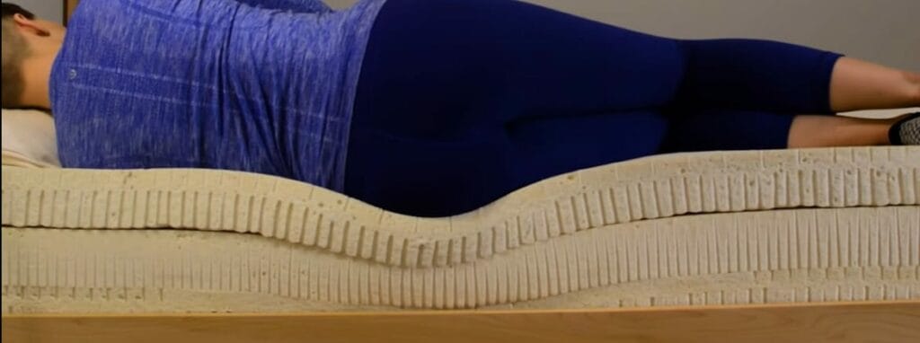 A woman laying on her side in a memory foam couch