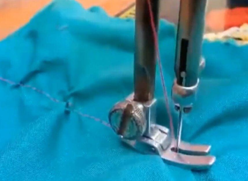 A sewing machine is being used to sew a piece of fabric