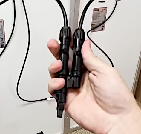 A person holding a same polarity leads together using combiners