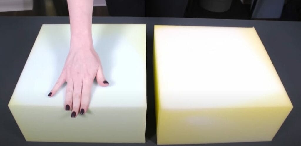 A woman's hand in one block of foam besides another block of foam