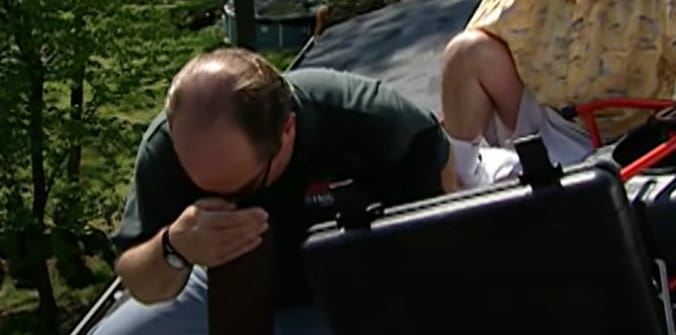 A person inspecting a vent for blockages