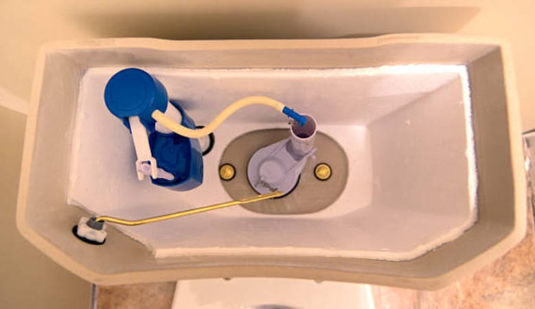 A top shot image of an empty toilet tank