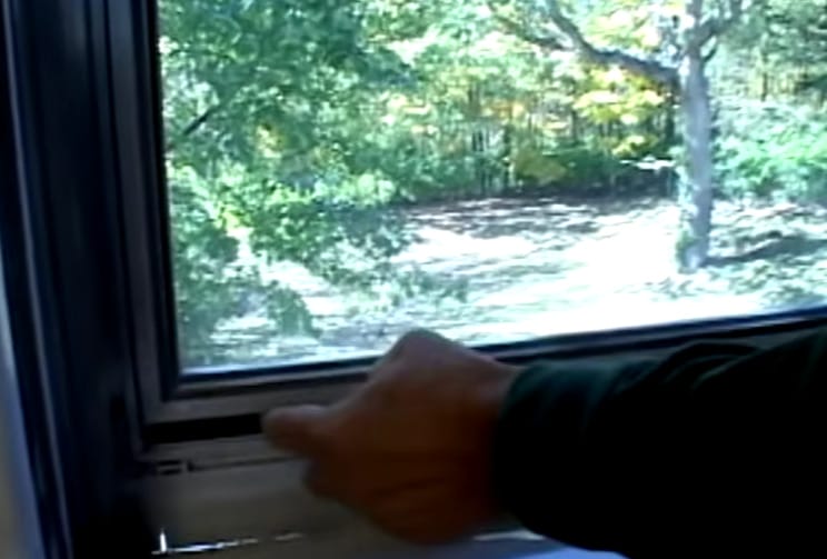 A person weatherstripping the window