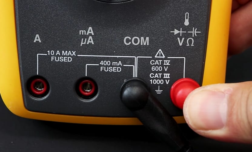 A person setting up the FLUKE digital multimeter