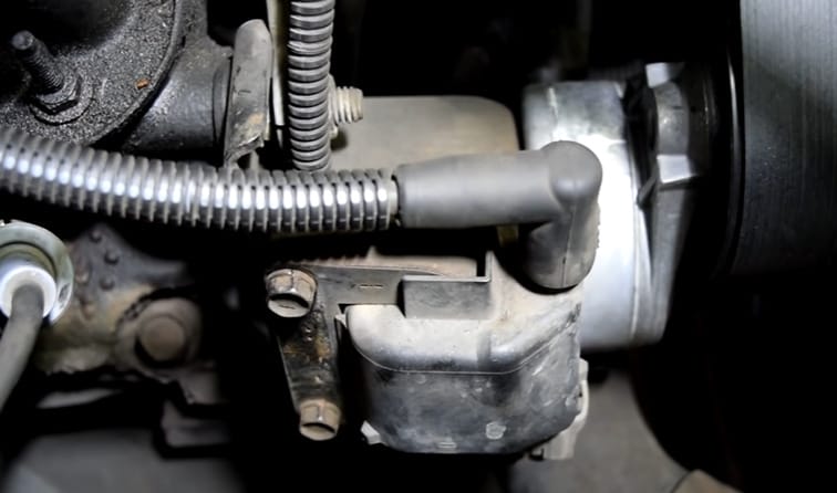 A close up of a car engine with a coil pack