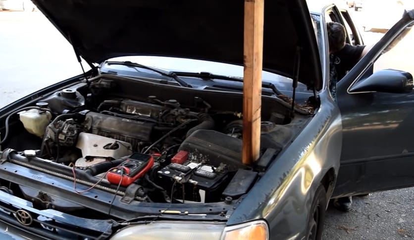 An open car hood showing its engine parts