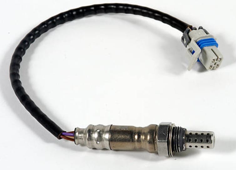 A person in blue gloves holding two 02 sensors