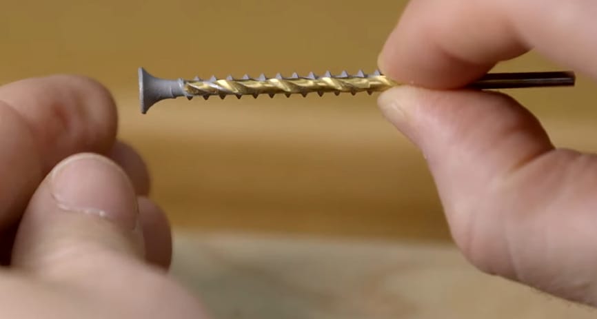 A person holding a drill bit