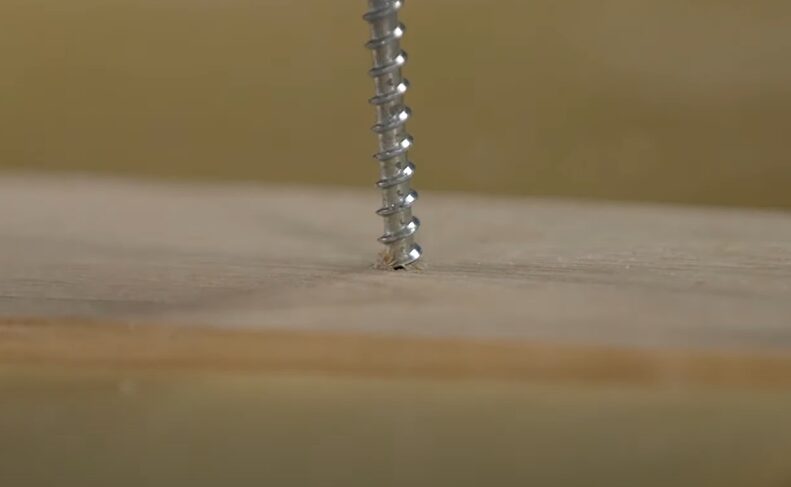 A drill bit on a piece of wood