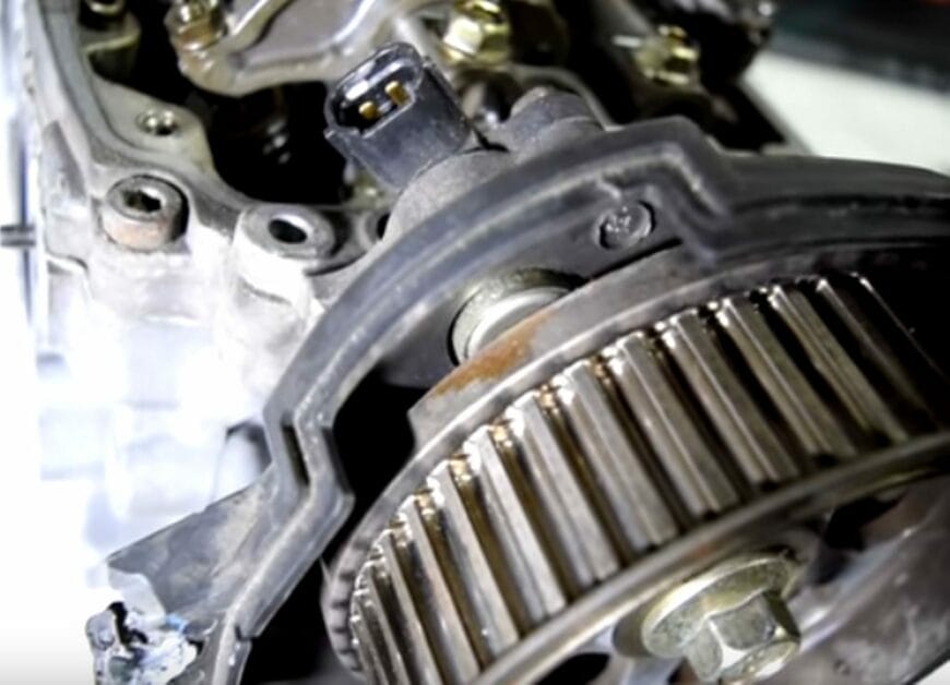 A CKP sensor, typically on top of the engine, behind the camshaft gears