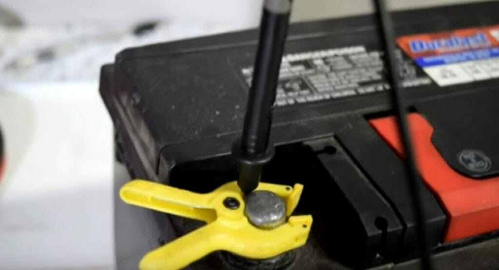 Connecting the black probe to the battery's negative terminal