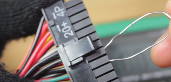 A person is holding a 24-pin connector