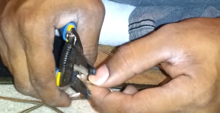 A person is cutting and stripping wire