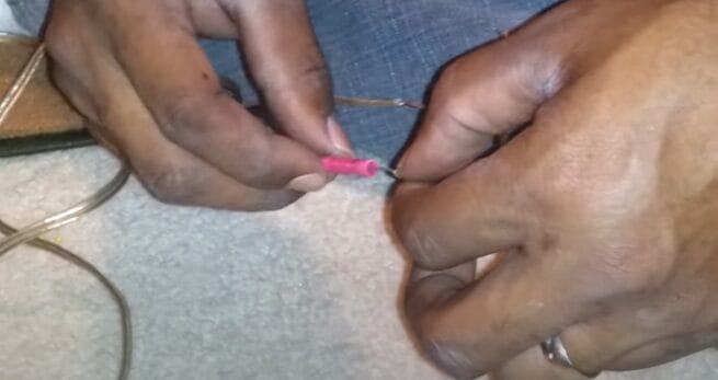A person is connecting a splice wire