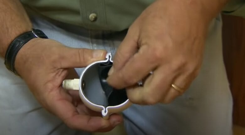 A person holding a water hammer arrestor