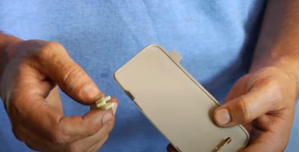 A person is holding a fuse box