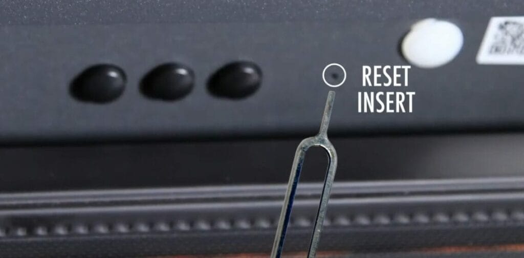 A close-up of a TV screen displaying the words "reset" and "insert.