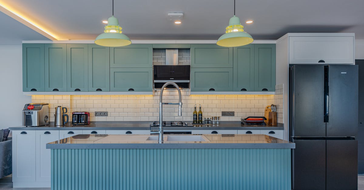 sleek contemporary kitchen with blue cabinets and stainless steel appliances