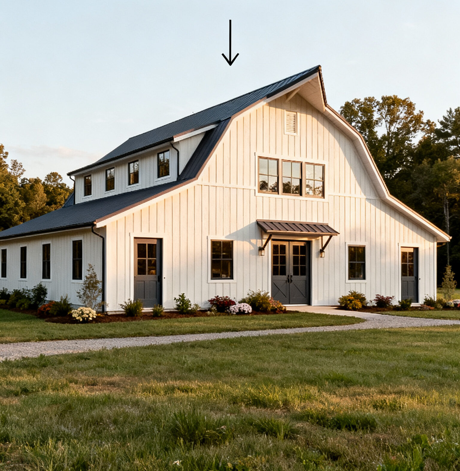 A modern white barn-style house with black trim sits on a grassy lawn under a clear sky; text above reads, "Country Living Feels Modern.