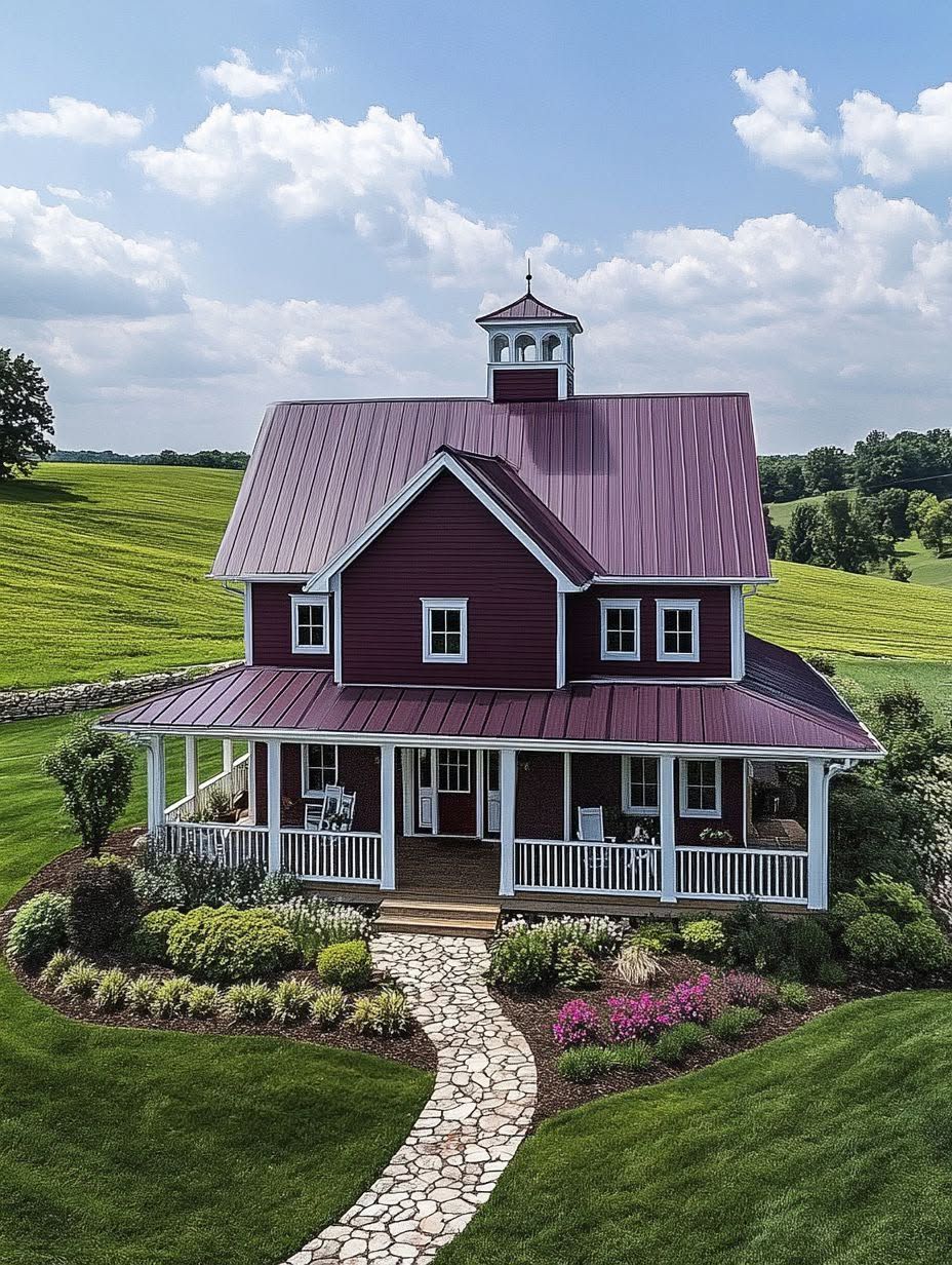 A red two-story farmhouse with white trim, a front porch, and a stone walkway, surrounded by landscaped gardens and green fields under a partly cloudy sky.