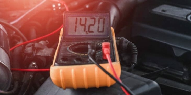 multimeter at the hood engine of a car