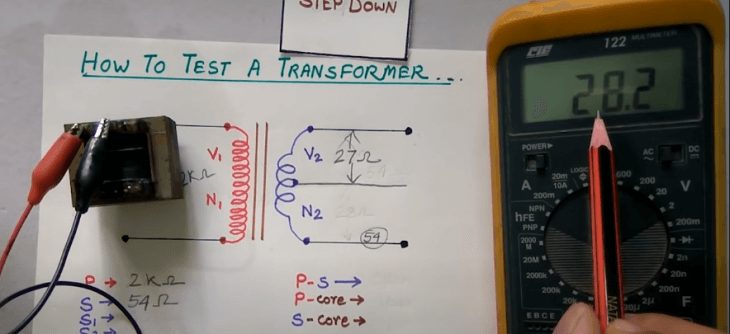technician reading the result for testing transformer with multimeter