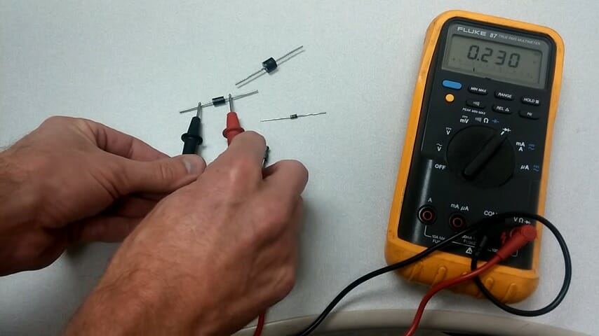 technician testing diode using multimeter