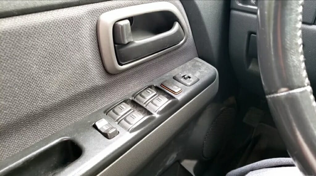 car window and door buttons on the driver's side