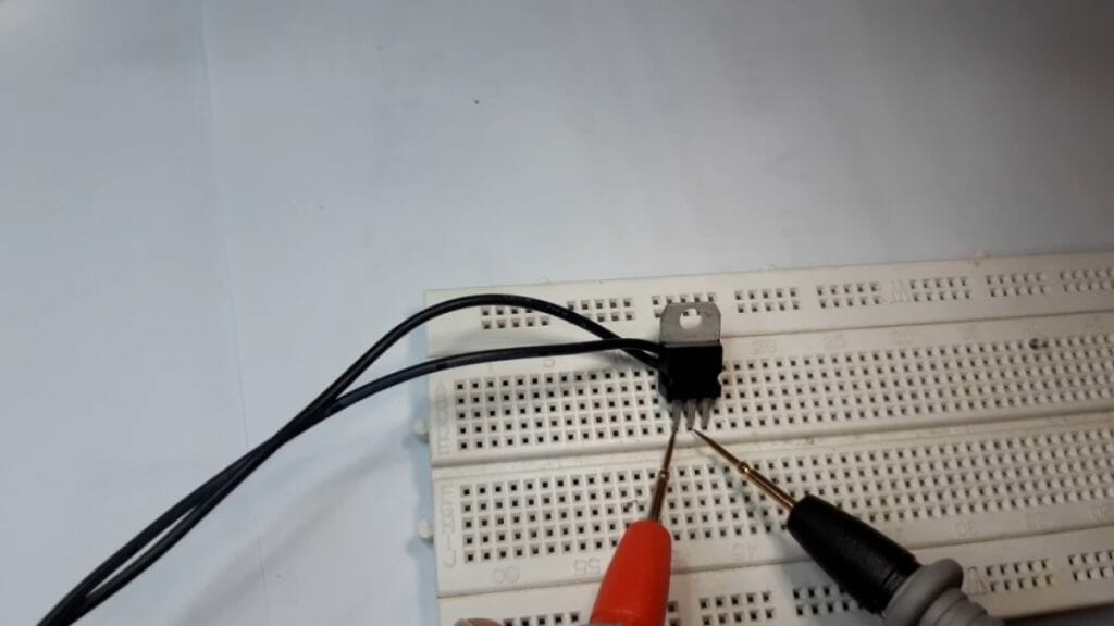 multimeter probes and 3-terminal voltage regulator