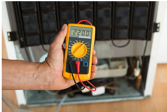 man holding a multimeter with 220 reading