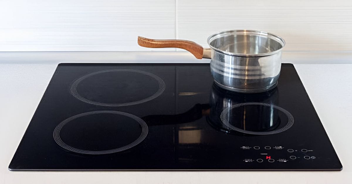 A four-burner electric stove with a casserole in one of the burner